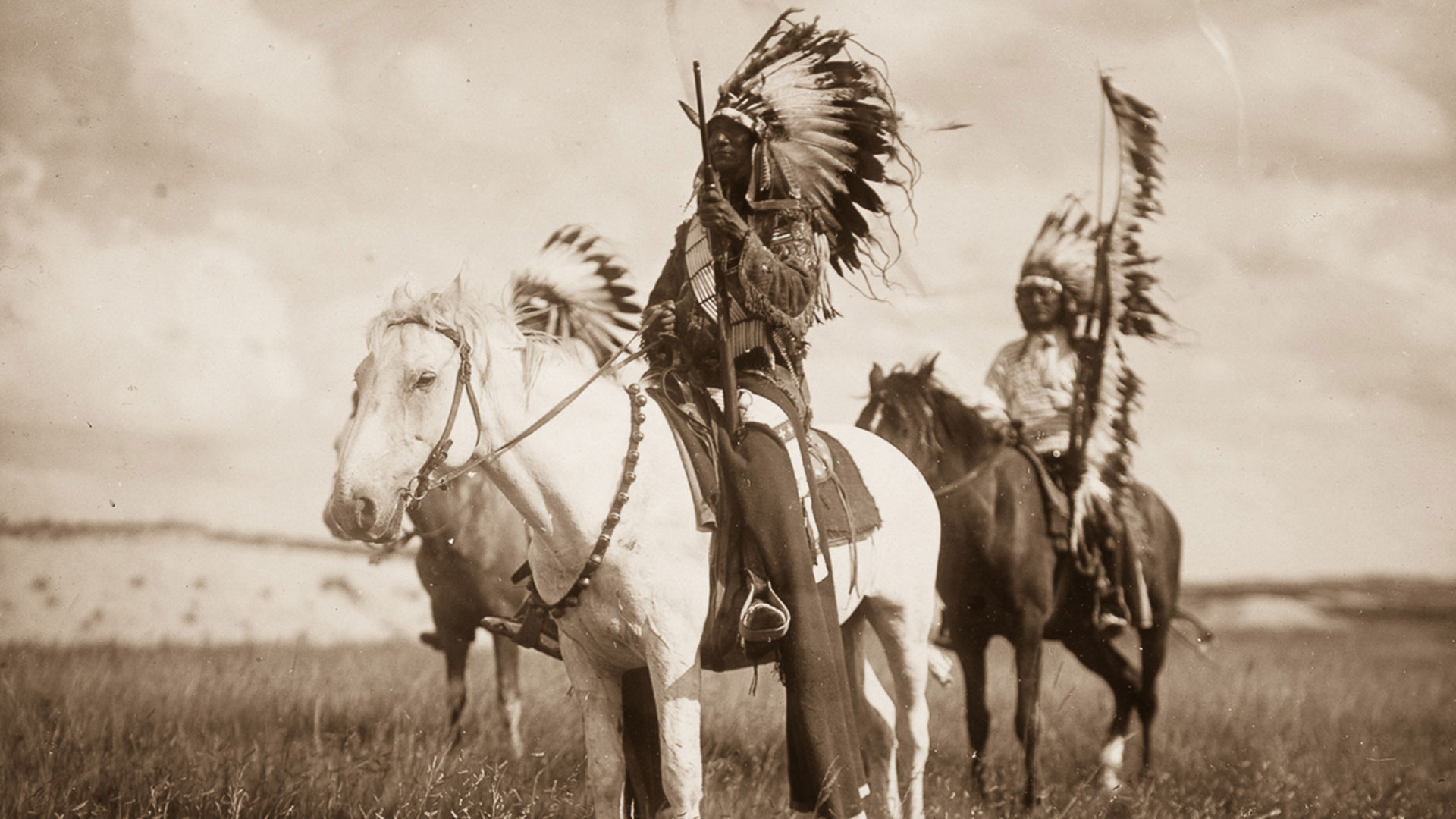 Image of two native americans on horses